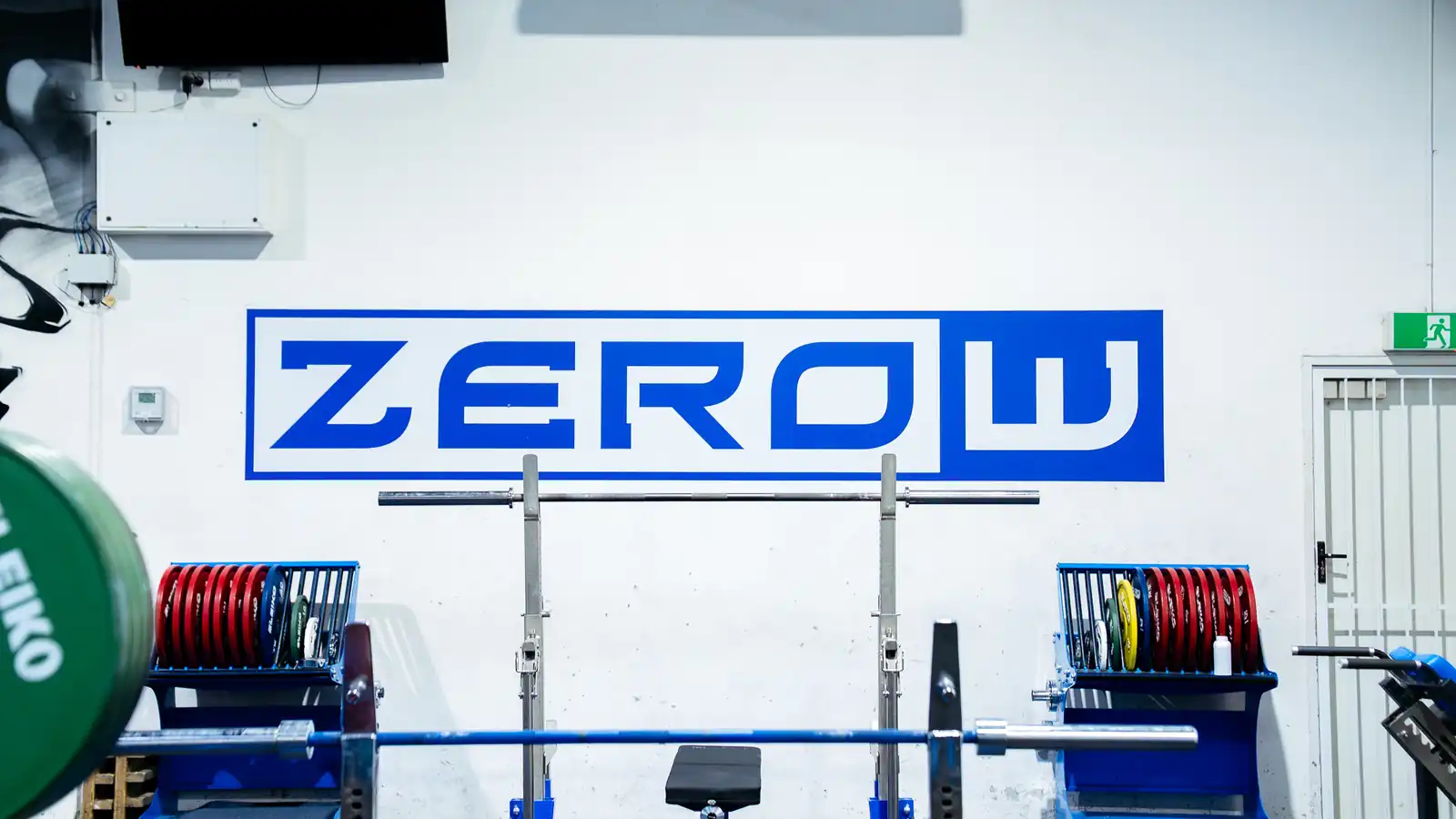 Ground ZeroW logo wall with a competition bench setup
